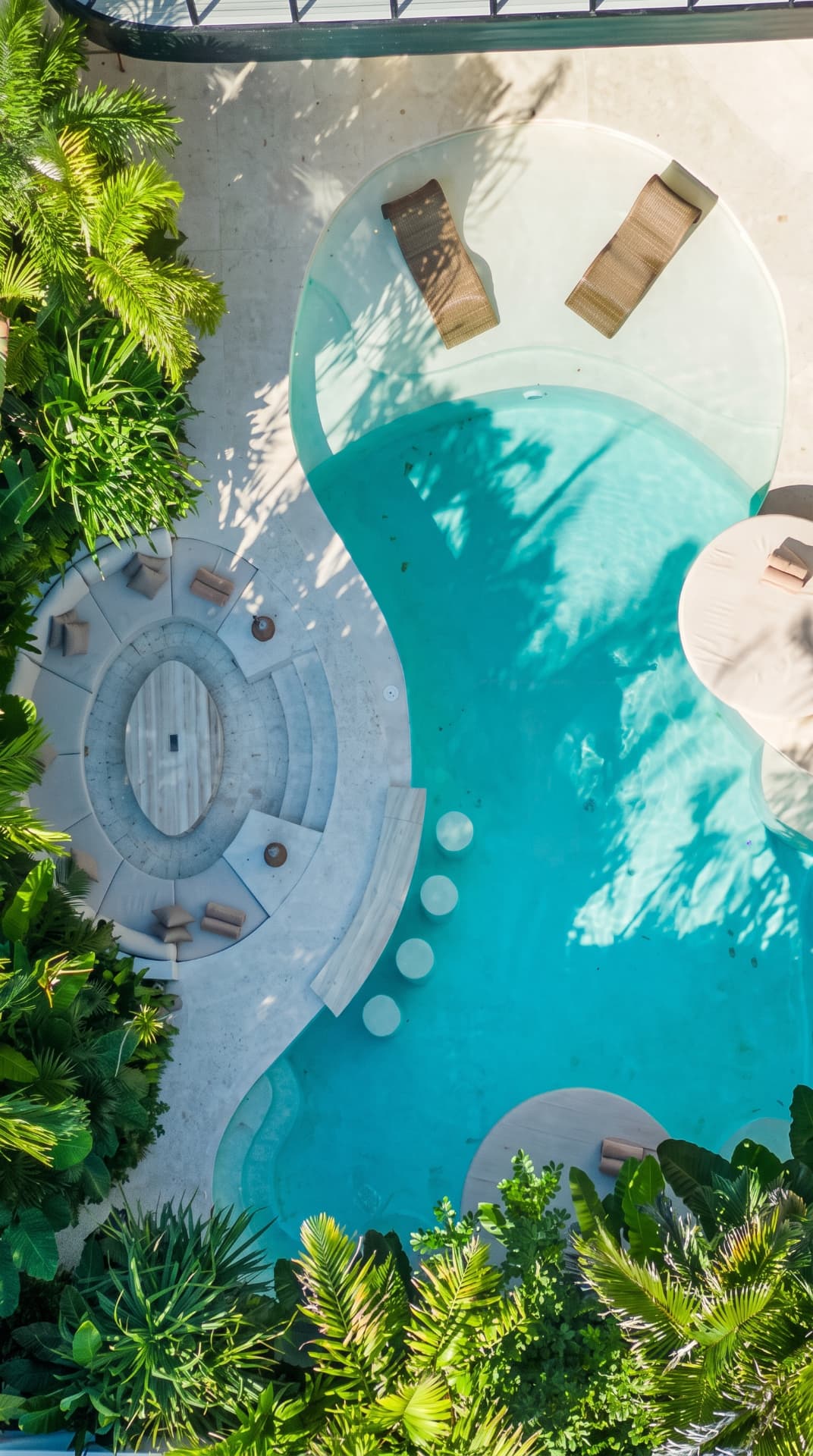 Aerial photograph of the empty curved villa pool