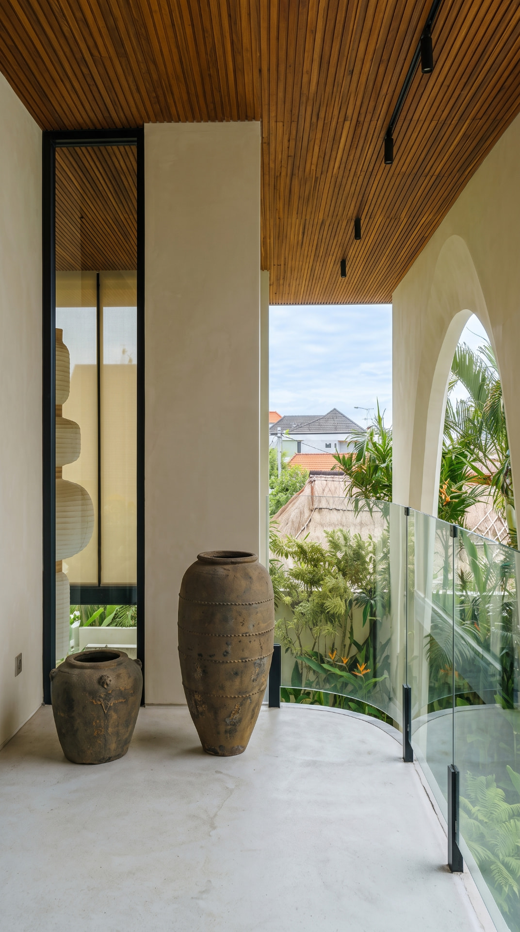 Empty villa balcony with terracotta urns and arched opening